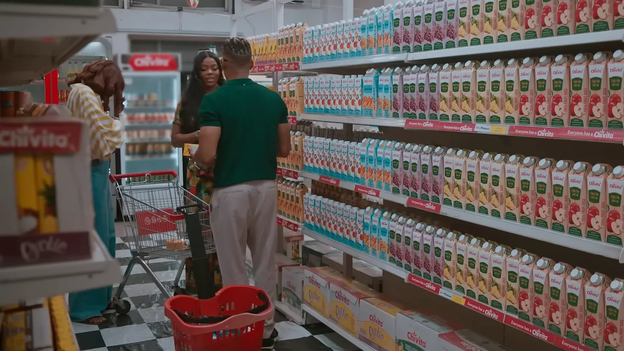 What’s Your Chivita? film still: two people meet in a supermarket aisle stocked with Chivita