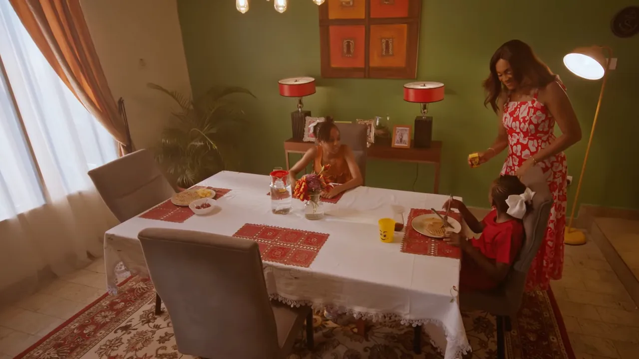 What’s Your Chivita? film still: a mother at home with her children at the table