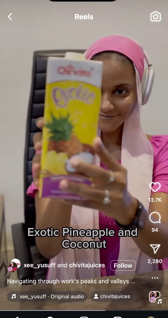 A creator holds up Chivita Exotic pineapple and coconut